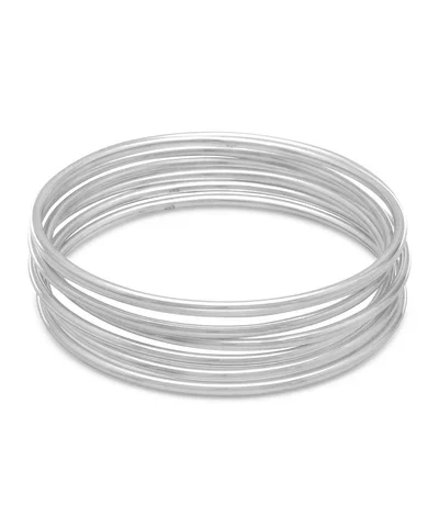 Set of .925 sterling silver minimalist bangles inspired by the Pleiades star cluster.