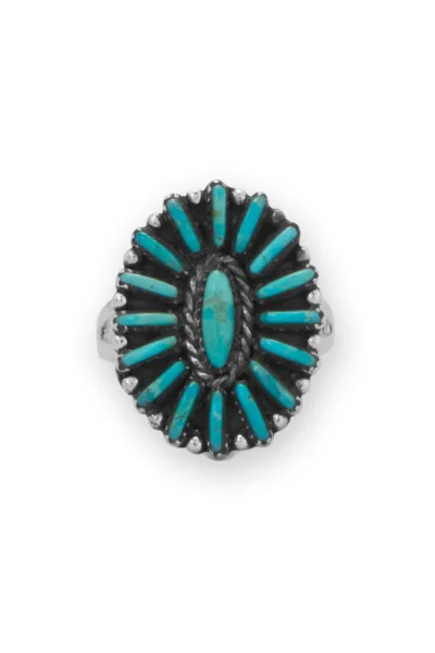 Sterling silver ring with natural turquoise stone in a floral bezel setting.
