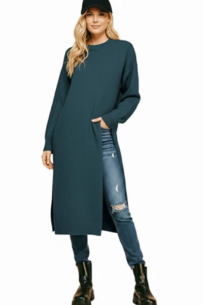 Deep‑teal longline sweater with dramatic side slit and round neckline.
