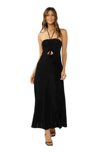 Woman wearing a black pointelle knit halter dress with ruched front and flowing hemline.