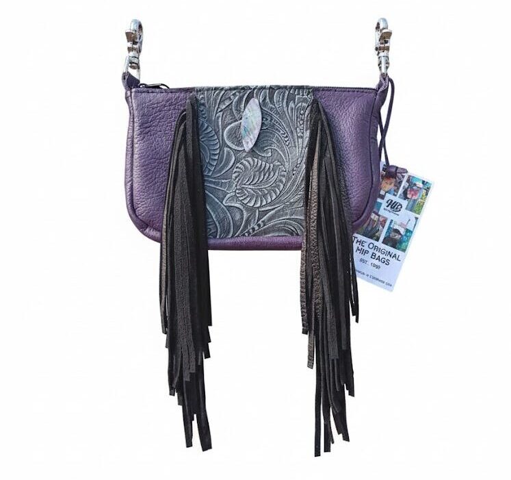 Purple leather hip bag with iridescent Mother of Pearl facial band, long fringe, and adjustable strap.