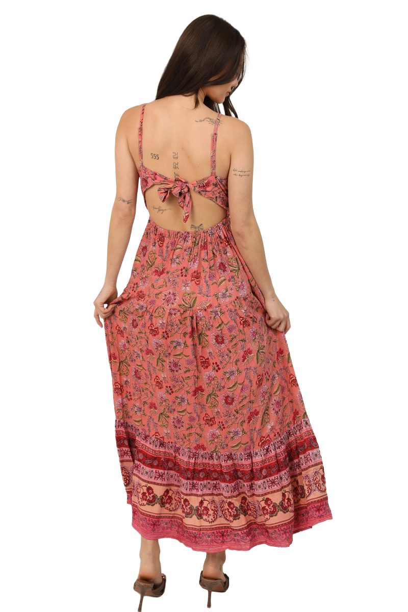 Back view of a coral wildflower‑print maxi dress featuring an open tie‑back and full skirt.