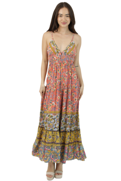 Front view of a coral patchwork‑print maxi dress with a V‑neckline, thin straps, and a flowing tiered skirt in blue and gold bands.