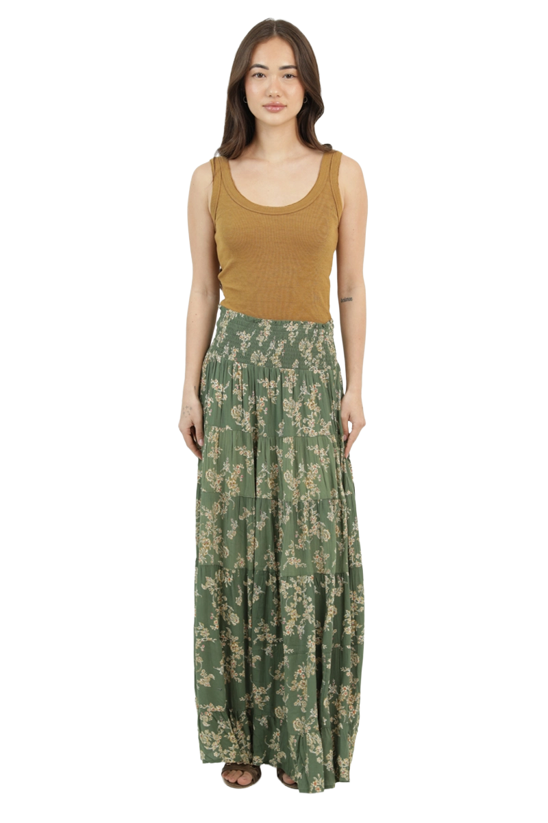 Front view of an olive floral A‑line maxi skirt with a smocked waistband and tiered, flowing movement.